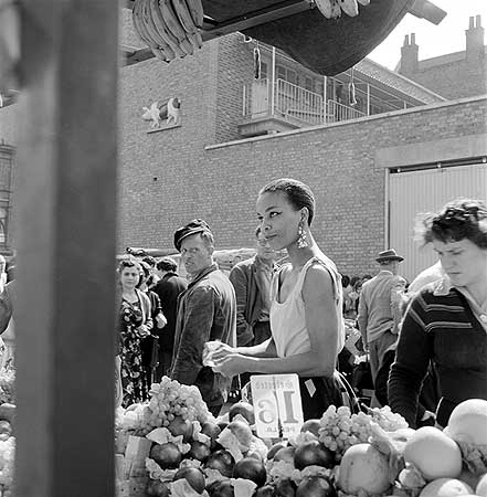 a-woman-buys-fruit-at-a-stall-in-a-north-london-street-market-photographer-john-gay-date-taken-1946-1959
