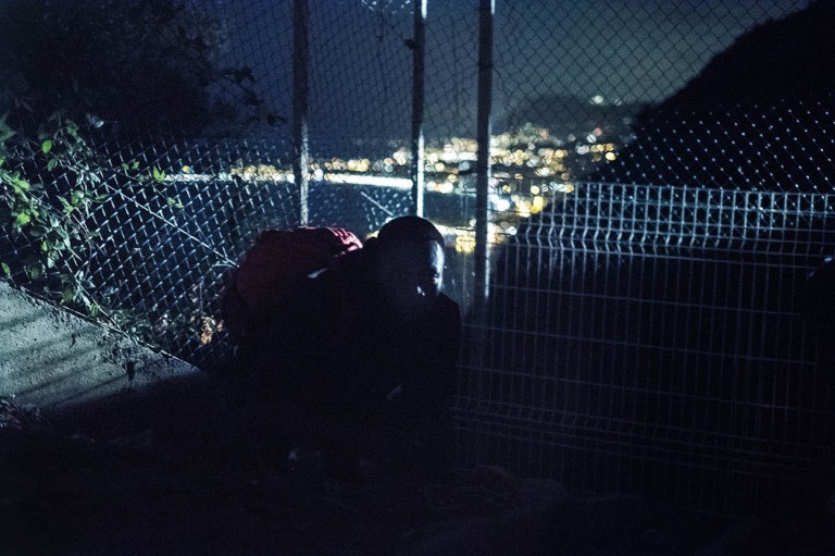 migrants run on night motorway at Italo-French border