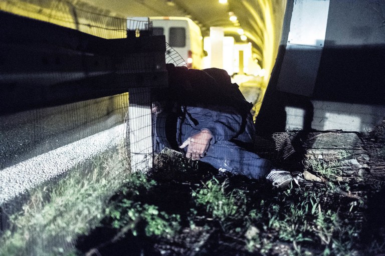 migrants run on night motorway at Italo-French border