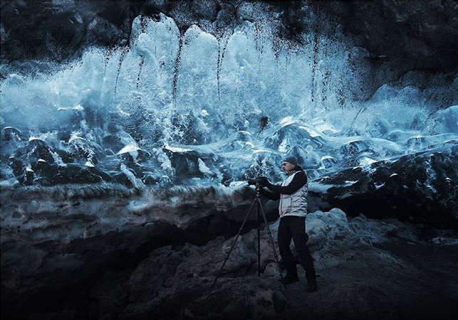 Michael Najjar taking photographs in an ice cave under the glacier in Iceland