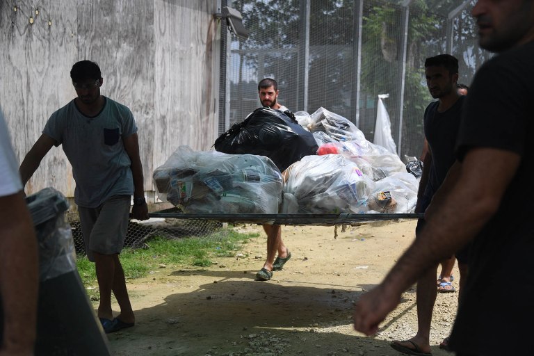 Asylum seekers in the Lombrum detention clean up camp after being abandoned by Australia.