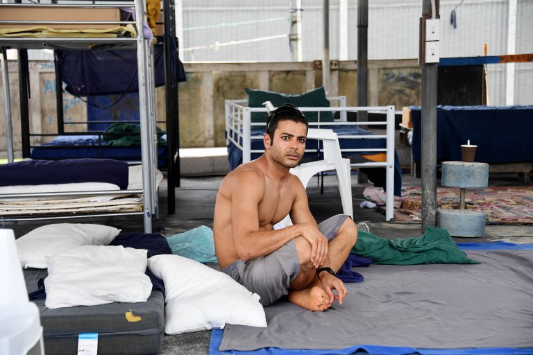 Iranian refugee Rezza Chenane sits wide eyed and rocking in the Lombrum detention. centre