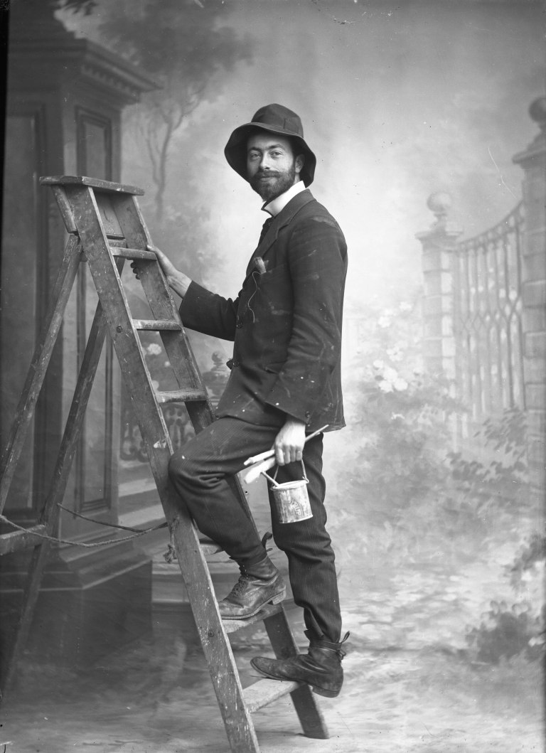 David Knights-Whittome Knights-Whittome, posed in the studio ‘painting_ his backdrops. n.d. Print, from glass negative (?) Sutton Local Studies &amp; Archives Centre, Sutto