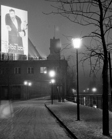 Art exhibition The Eternal Jew - View from the Uferstrasse to the library building of the German Museum, 1937. The huge poster of the propaganda exhibition The Eternal Jew was illuminated at night.