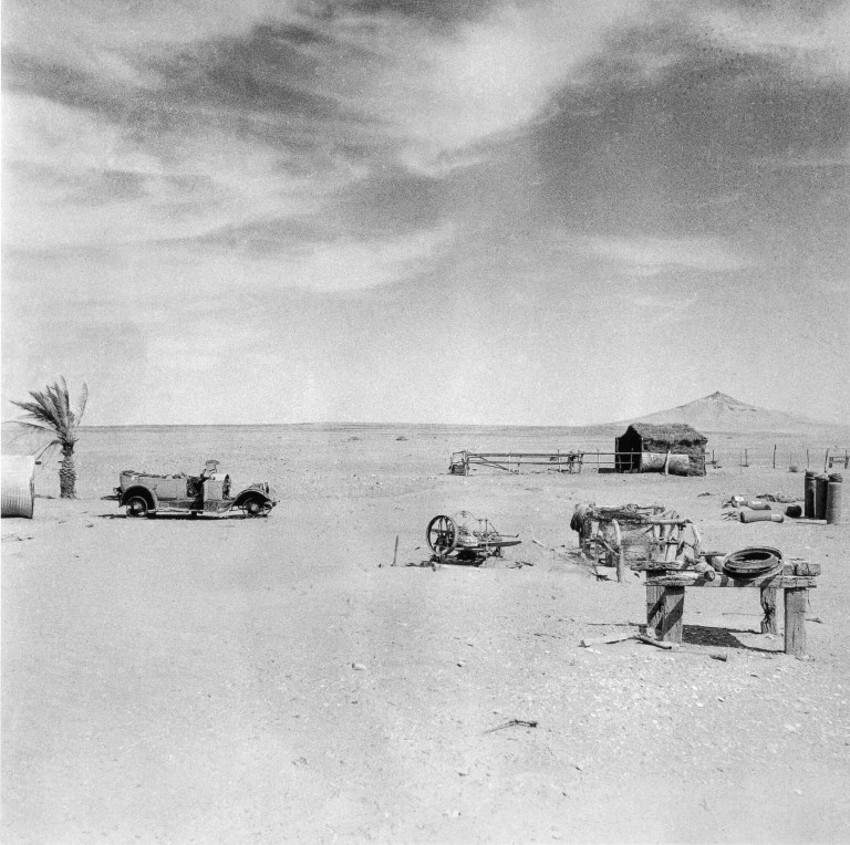 Stock shelter, an old automobile and machinery, Queensland, 1952